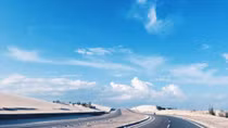 In central Vietnam, a dreamlike road by the blue ocean and white sand dunes
