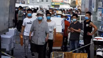 Beijing district in 'wartime emergency' after virus spike shuts market