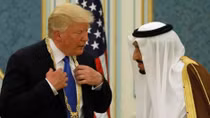 Under fire at home, Trump wins warm welcome in Saudi