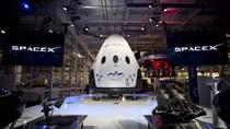 SpaceX says it will fly two people to the moon next year