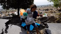 Lights, TVs back on in Indonesia quake city, but fate of thousands unknown