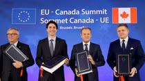 EU, Canada sign free trade deal but battle not over