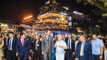 French Prime Minister Édouard Philippe walks about Hanoi pedestrian streets