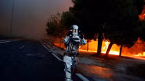 Wildfire kills at least 50 near Athens, families flee to beaches
