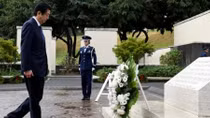 Japan's Abe pays respects at Hawaii memorials on eve of Pearl Harbor trip