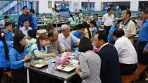 Senior leaders having meals with workers, poor people