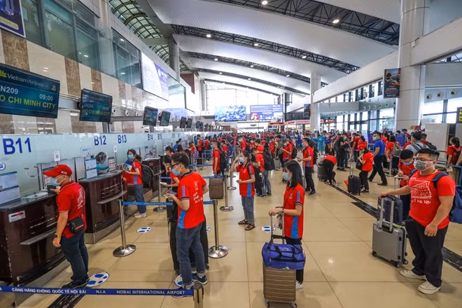 Students from the Hanoi Medical University keep their distance as they check-in at Noi Bai International Airport in Hanoi.