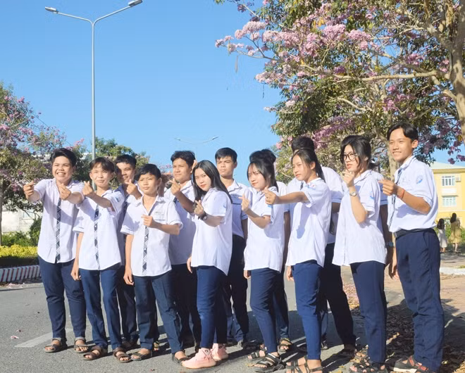 A group of friends delightfully take photos of the blooming trees.