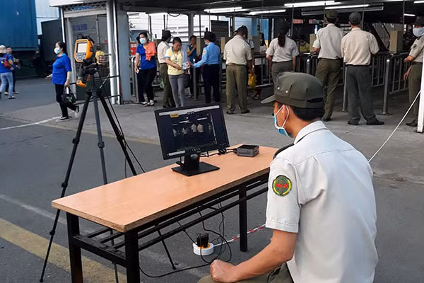 Some companies use thermal screening devices to check the body temperature of its workers. Some companies use thermal screening devices to check the body temperature of its workers.
