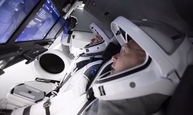 Doug Hurley, foreground, and Bob Behnken work in SpaceX’s flight simulator at the Kennedy Space Center in Cape Canaveral, Florida. Photograph: AP