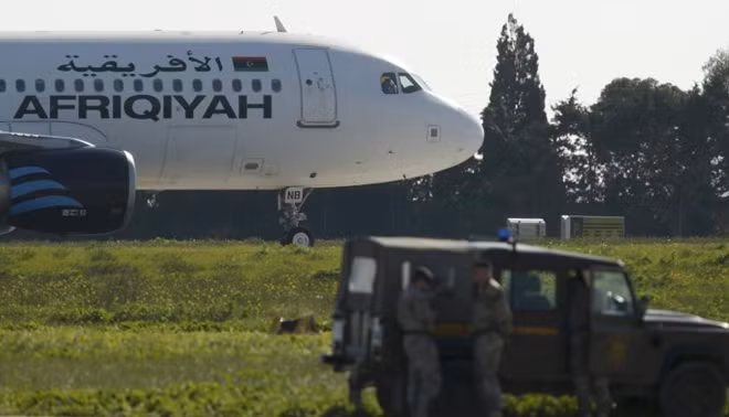 Maltese troops survey a hijacked Libyan Afriqiyah Airways Airbus A320 on the runway at Malta Airport, December 23, 2016. REUTERS/Darrin Zamit-Lupi