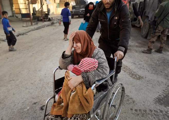 A displaced Iraqi woman cries while fleeing her home, as Iraqi forces battle with Islamic State militants, in western Mosul, Iraq March 8, 2017. REUTERS/Zohra Bensemra A displaced Iraqi woman cries while fleeing her home, as Iraqi forces battle with Islamic State militants, in western Mosul, Iraq March 8, 2017. REUTERS/Zohra Bensemra