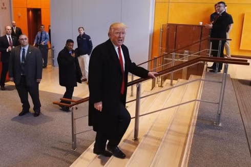 U.S. President elect Donald Trump walks up a staircase to depart the lobby of the New York Times building after a meeting in New York, U.S., November 22, 2016.