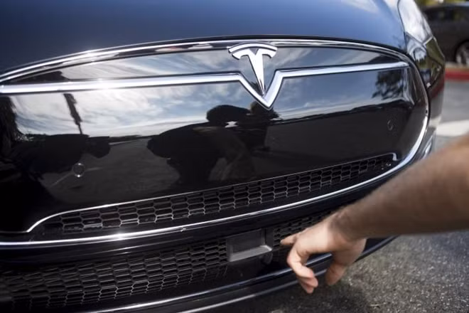 The radar technology of a Tesla Model S containing autopilot features is pointed out during a Tesla event in Palo Alto, California.