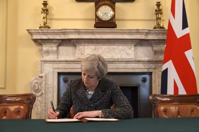 British Prime Minister Theresa May in the cabinet office signs the official letter to European Council President Donald Tusk invoking Article 50 and the United Kingdom's intention to leave the EU on March 28, 2017 in London, England. REUTERS/Christopher Furlong/Pool