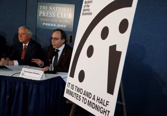 'Bulletin of the Atomic Scientists' board members David Titley (L) and Chairman Lawrence Krauss speak at a news conference where the board revealed that it has moved the minute hand of their 'Doomsday Clock' by 30 seconds to a more ominous 2-1/2 minutes from midnight at the National Press Club in Washington, U.S. January 26, 2017. REUTERS/Jim Bourg