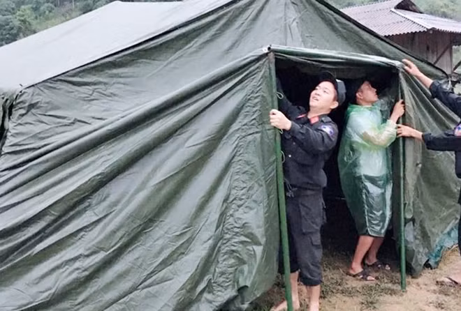 Police officers set up tents as temporary accommodation for residents in the flood-hit areas. Police officers set up tents as temporary accommodation for residents in the flood-hit areas.