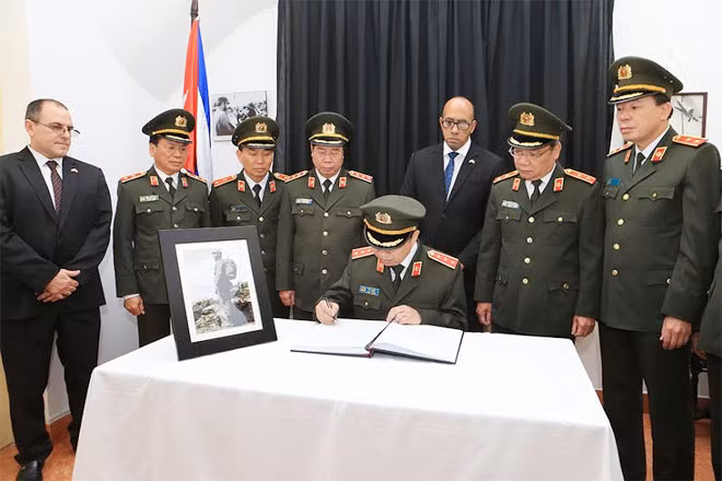 Minister To Lam writing on the funeral book.