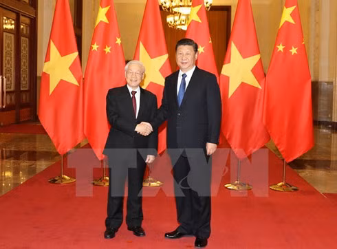 Chinese General Secretary and State President Xi Jinping (R) welcomes Party General Secretary Nguyen Phu Trong