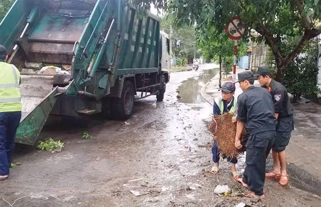 Police officers helping local people to clean up a road. Police officers helping local people to clean up a road.