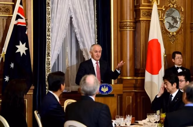 File photo: Australian Prime Minister Malcolm Turnbull delivers a speech while Japanese Prime Minister Shinzo Abe listens at a banquet at the Akasaka guesthouse in Tokyo December 18, 2015. REUTERS/Yoshikazu Tsuno