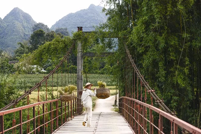 A farmer walks home from the fields.