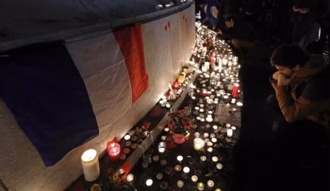 A man pays his respects during a gathering at the Place de la Republique in Paris, France, November 13, 2016, after ceremonies held for the victims of last year's Paris attacks which targeted the Bataclan concert hall as well as a series of bars and killed 130 people. REUTERS/Philippe Wojazer