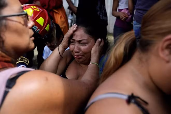 Family members react as they wait for news of their loved ones after a fire broke at the Virgen de Asuncion home in San Jose Pinula, on the outskirts of Guatemala City, Guatemala March 8, 2017. REUTERS/Saul Martinez