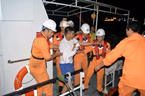 Crewmembers on board ship SAR27-01 taking Niel Pasadas Veronilla ashore for treatment.