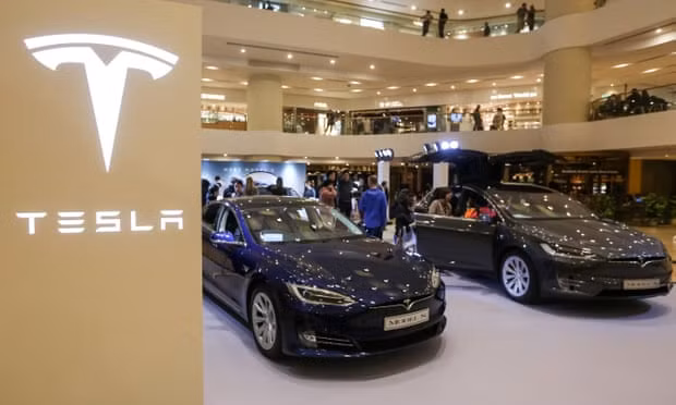 Tesla vehicles on display at a shopping mall in Hong Kong. The carmaker will now shut only half the stores earmarked for closure. Photograph: Vivek Prakash/Getty Images