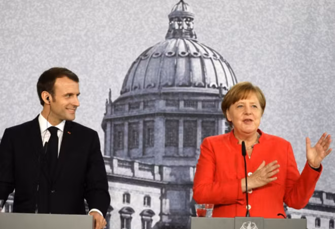 German Chancellor Angela Merkel and French President Emmanuel Macron hold a news conference at the building site of the Humboldt Forum in Berlin, Germany, April 19, 2018. Kay Nietfeld/Pool via Reuters