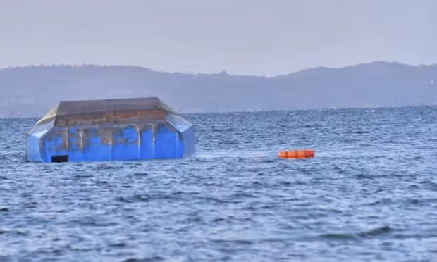 The upturned passenger ferry MV Nyerere floats in the water near Ukara Island in Lake Victoria, Tanzania. Photograph: AP