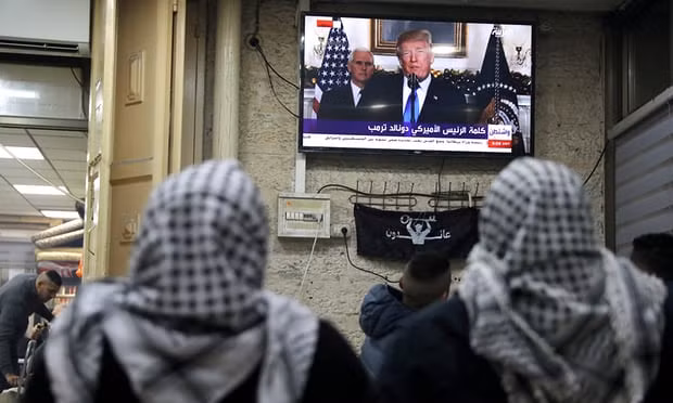 People watching US President's speech on TV. Photo: Reuters People watching US President's speech on TV. Photo: Reuters