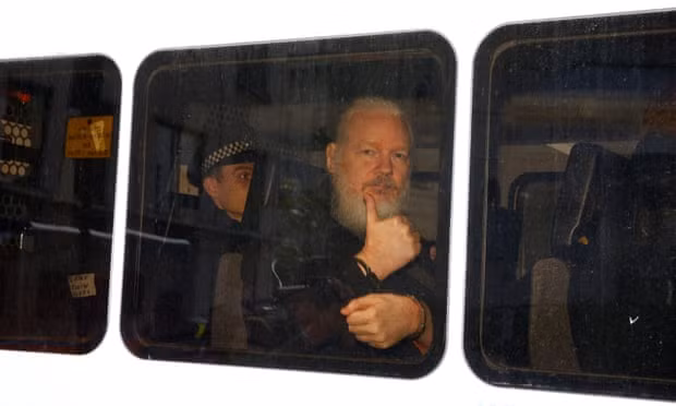 Assange in a police van after he was arrested by British police. Photograph: Henry Nicholls/Reuters
