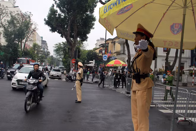 Traffic police women guide traffic flows and direct vehicles to parking lots at venues of the US-DPRK Summit.