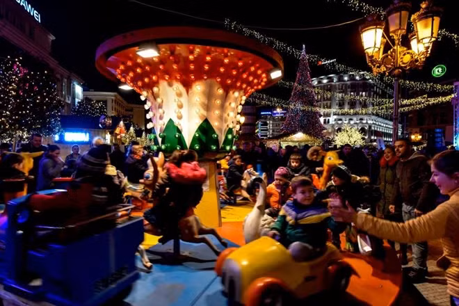 Children ride a merry-go-round in front of the big Christmas tree at the decorated main square in the center of Skopje, Macedonia, on Dec. 30.