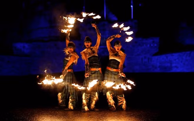 Members of PyroCeltica pose in front of Edinburgh Castle in advance of Edinburgh's Hogmanay torchlit procession down the Royal Mile in Edinburgh, Scotland, on Dec. 30. It is expected to bring large number of visitors from all over the world for this traditional New Year celebrations, which run over three days.