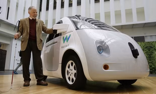 Steve Mahan, who is blind, stands by the Waymo driverless car during a Google event. Photo: Eric Risberg/AP