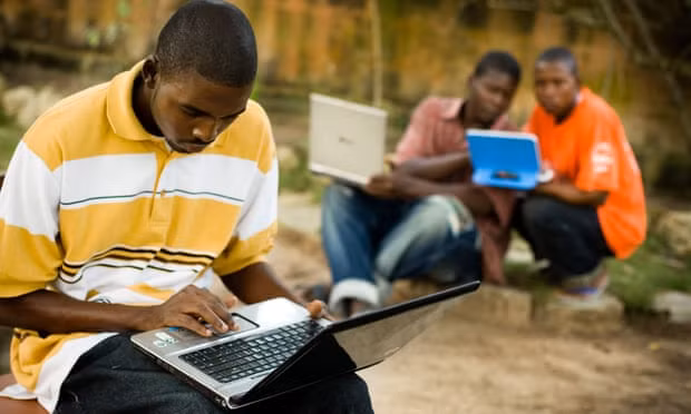 Students use laptops to browse the internet over a wireless network in the town of Kokrobitey, Ghana. Photograph: Alamy