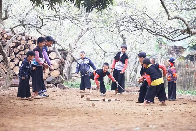 Boys play spinning top, a popular game among the H'Mong community.
