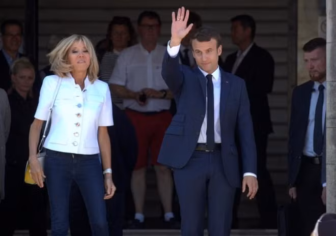 French President Emmanuel Macron and his wife Brigitte leave the polling station after voting in the first of two rounds of parliamentary elections in Le Touquet, France, June 11, 2017. REUTERS/Philippe Wojazer