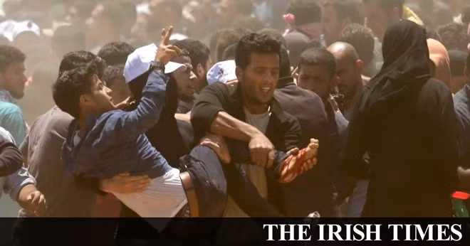 An injured protestor is moved after conflicts with Israeli soldiers in the Gaza Strip that borders Israel on May 14. Photo: The Irish Times