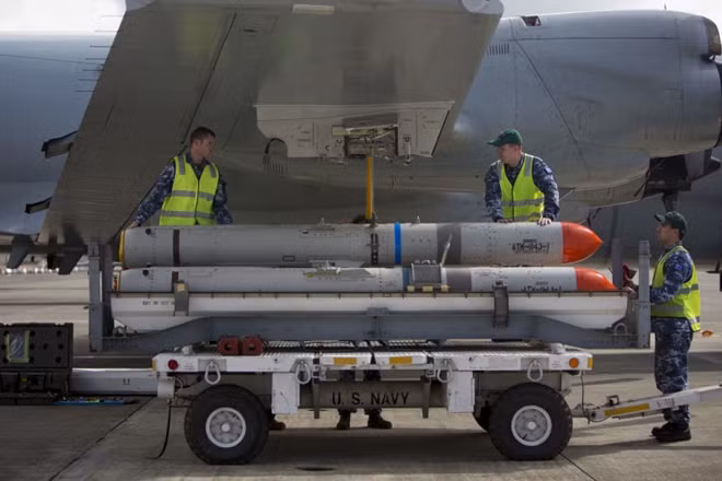 Weapons handlers load Harpoon missile onto an Australian P-3C Orion patrol aircraft. Australian Defence Force photo by ABIS Kayla Hayes, via Department of Defense.