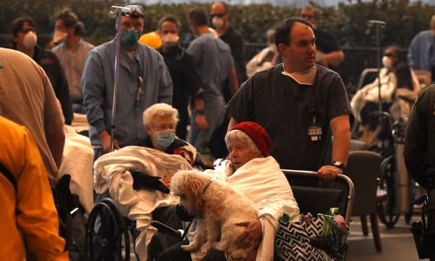 Hospital workers and first responders evacuate patients from the Feather River hospital in Paradise, California. Photograph: Justin Sullivan/Getty Images