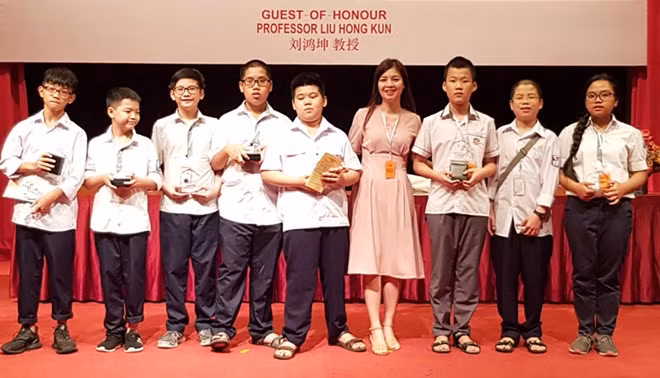 Eight members of the Vietnamese team pose for a group photo.
