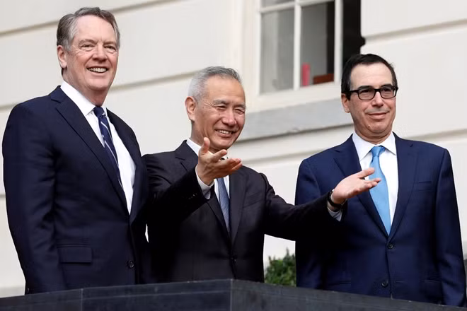 China's Vice Premier Liu He gestures to the media between U.S. Trade Representative Robert Lighthizer (L) and Treasury Secretary Steve Mnuchin before the two countries' trade negotiations in Washington, U.S., October 10, 2019.