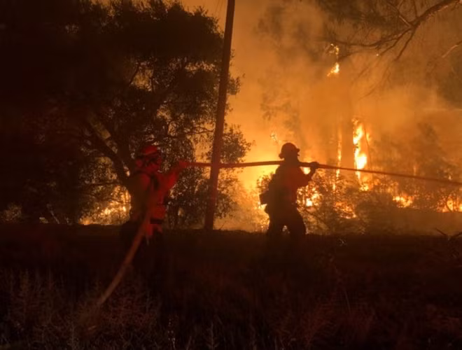 Firefighters work at the site of a wildfire in Goleta, California, U.S., July 6, 2018 in this image obtained on social media. Mike Eliason/Santa Barbara County Fire/via REUTERS