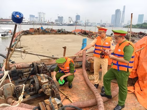Environmental police are inspect a sand dredging boat Environmental police are inspect a sand dredging boat