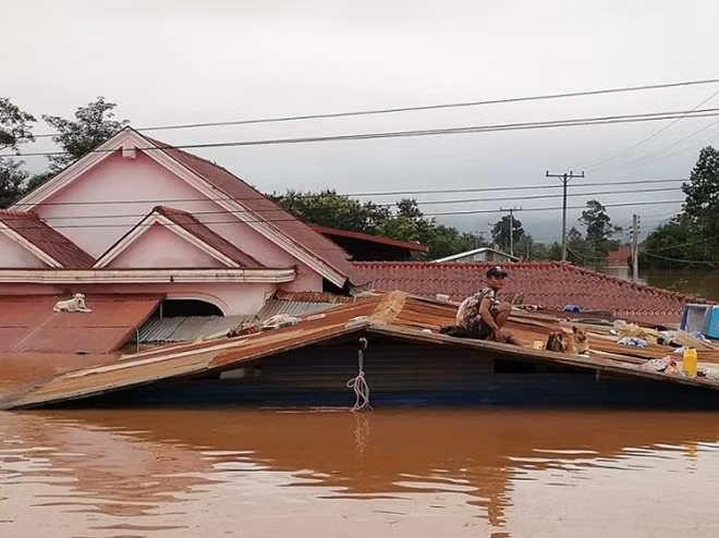 The surge of water submerged homes and forced villagers to seek safety on this roof