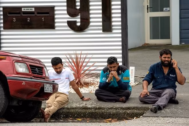 Grieving members of the public following a shooting at the Al Noor mosque in Christchurch. REUTERS.